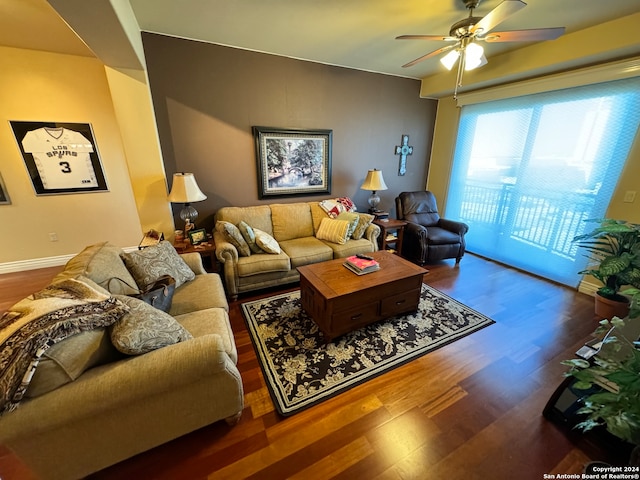 living room with ceiling fan and dark hardwood / wood-style floors