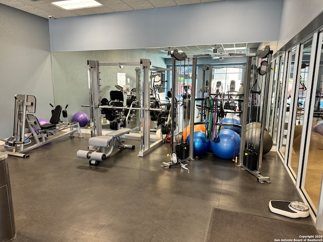 workout area featuring a paneled ceiling