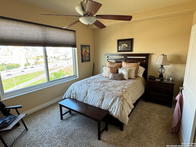 bedroom featuring dark carpet and ceiling fan