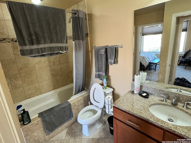 full bathroom with tile flooring, shower / bath combination with curtain, toilet, and vanity