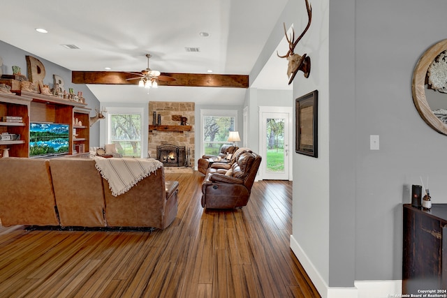 living room featuring beamed ceiling, ceiling fan, dark hardwood / wood-style floors, and a fireplace