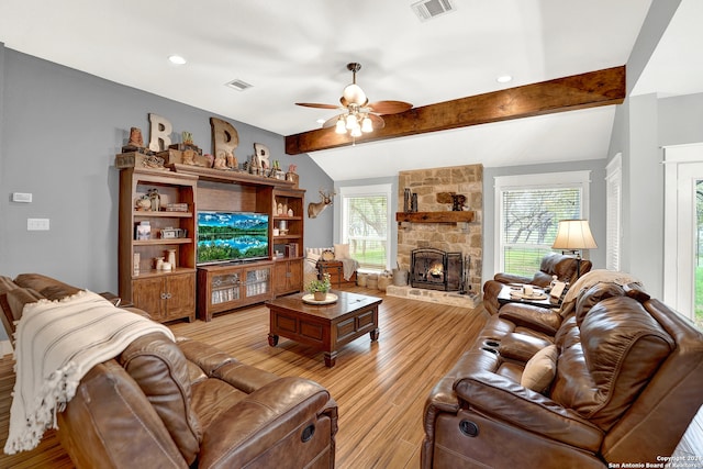 living room with vaulted ceiling with beams, light hardwood / wood-style floors, ceiling fan, and a fireplace