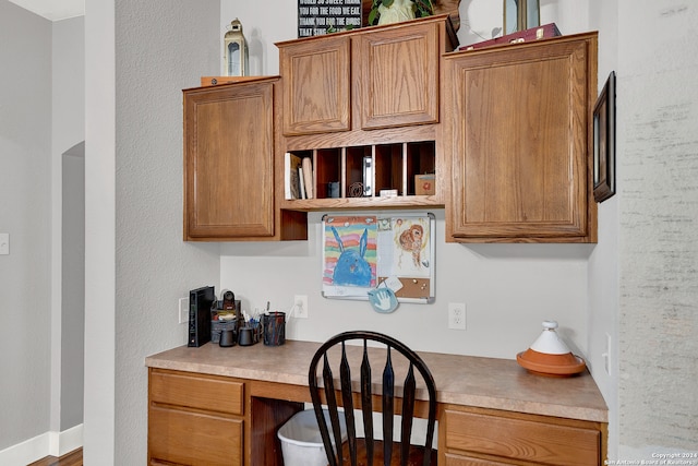 office area featuring built in desk and wood-type flooring