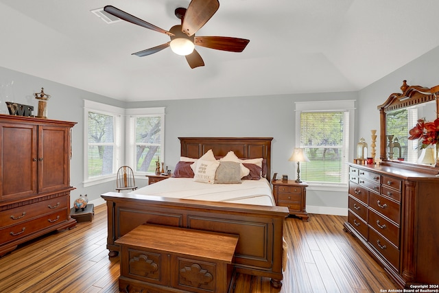 bedroom with dark hardwood / wood-style floors, ceiling fan, and vaulted ceiling