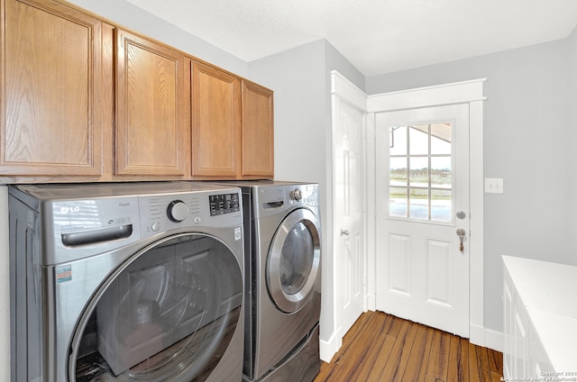 laundry room featuring cabinets, dark hardwood / wood-style floors, and separate washer and dryer