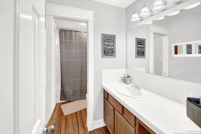 bathroom featuring wood-type flooring, toilet, and vanity