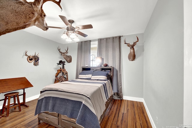 bedroom featuring dark hardwood / wood-style flooring and ceiling fan