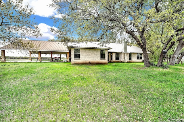 rear view of property with a lawn