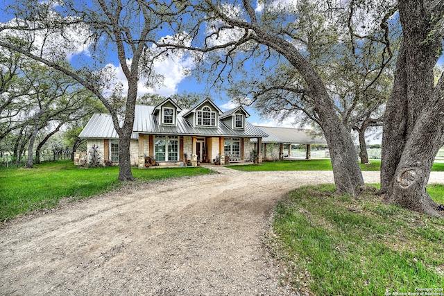 view of front of home with a porch and a front yard