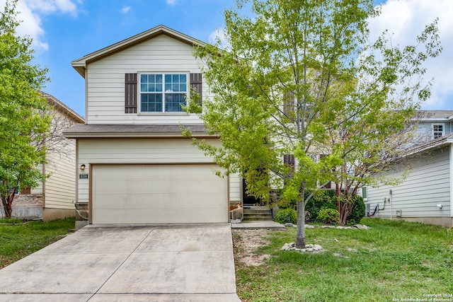 view of front of property with a front lawn and a garage