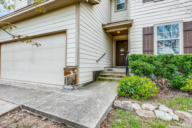 view of exterior entry with a garage