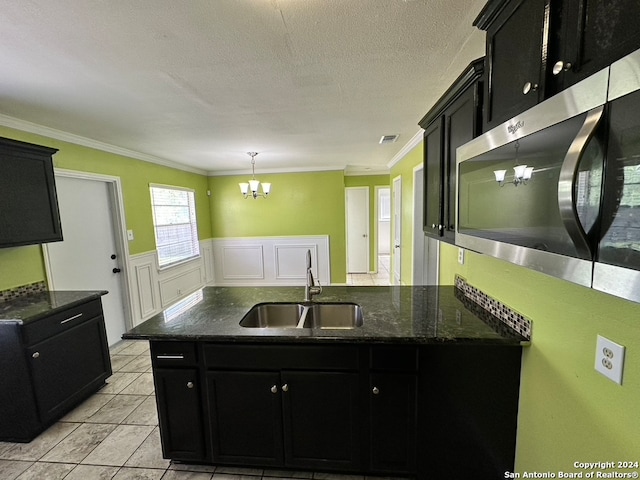 kitchen with decorative light fixtures, light tile flooring, an inviting chandelier, sink, and ornamental molding