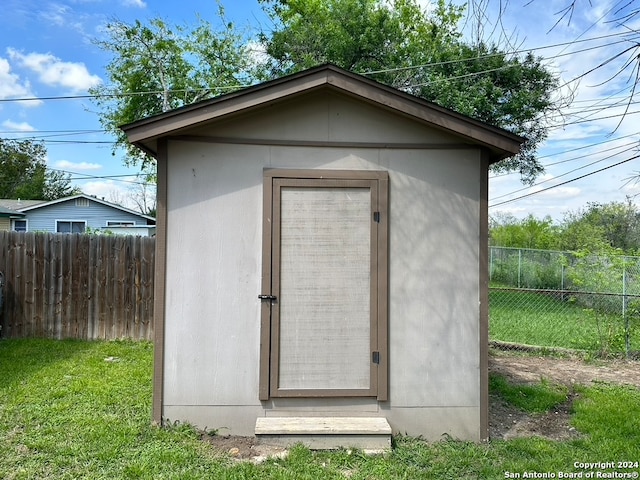 view of shed / structure with a lawn