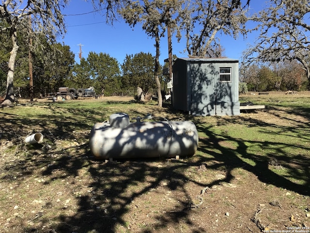 view of storm shelter with a storage unit