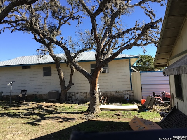 view of side of property with central AC unit