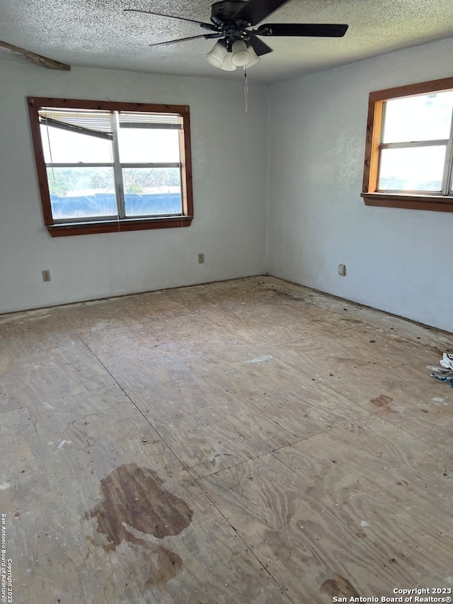 spare room featuring a textured ceiling and ceiling fan