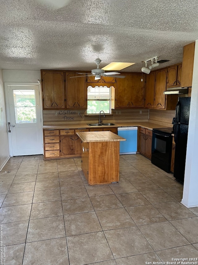 kitchen with ceiling fan, sink, light tile floors, and black appliances