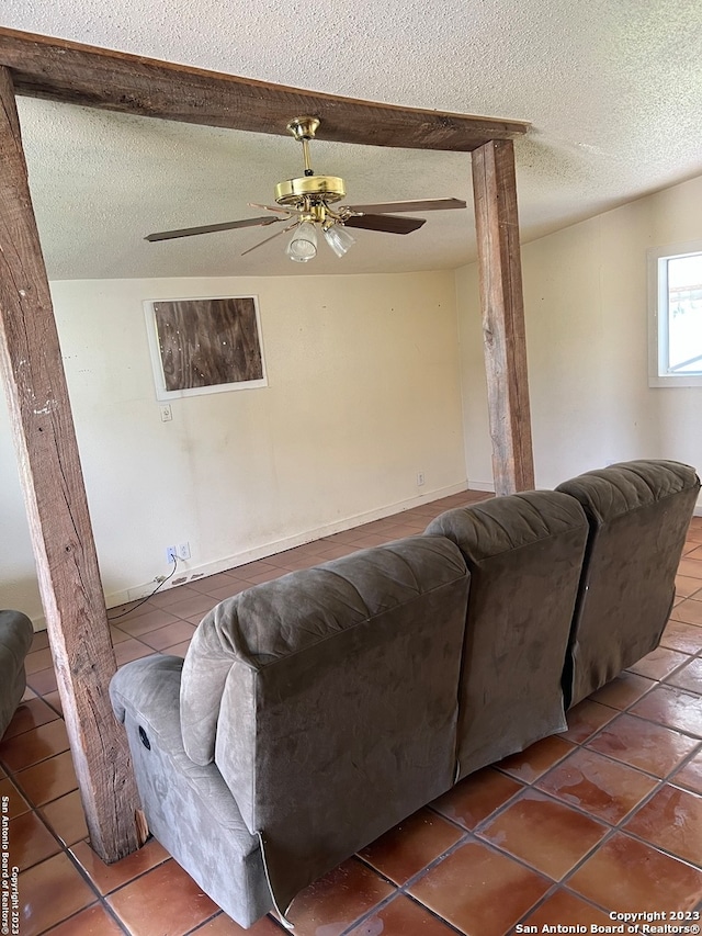 tiled living room featuring a textured ceiling and ceiling fan