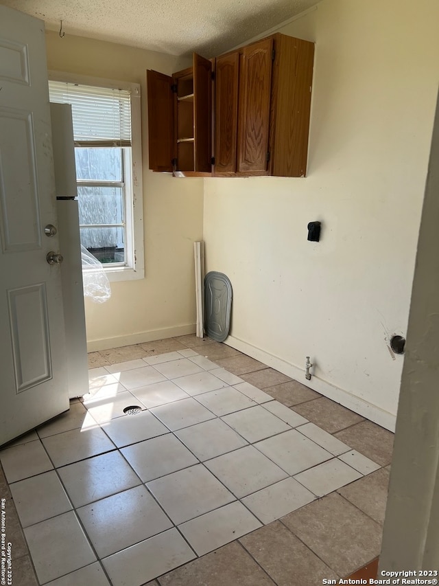 washroom with light tile floors