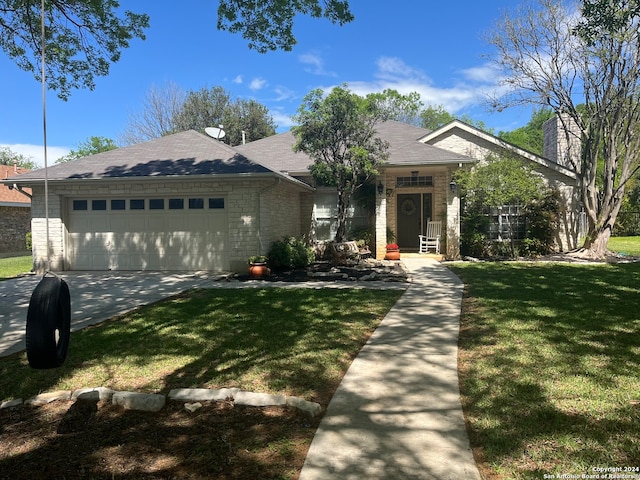 single story home featuring a front yard and a garage