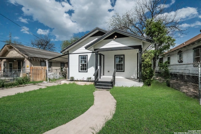 bungalow-style home featuring a porch and a front lawn