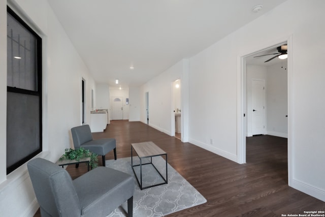 living room featuring dark hardwood / wood-style flooring and ceiling fan