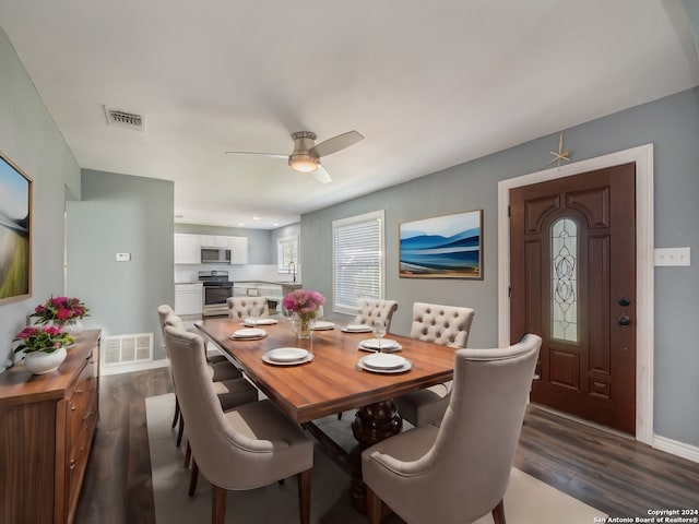 dining room featuring dark hardwood / wood-style flooring, ceiling fan, and sink