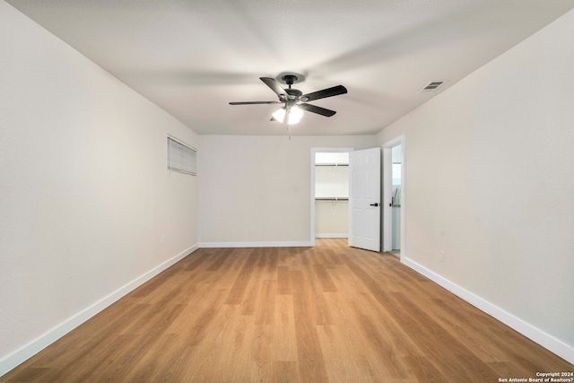 empty room featuring ceiling fan and light hardwood / wood-style flooring