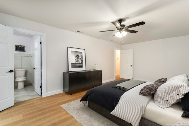 tiled bedroom with connected bathroom and ceiling fan