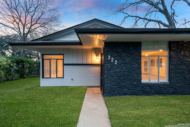 exterior entry at dusk with a yard