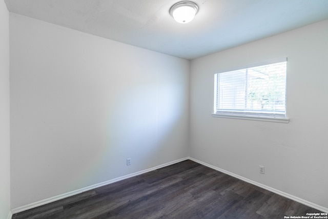 spare room featuring dark hardwood / wood-style floors