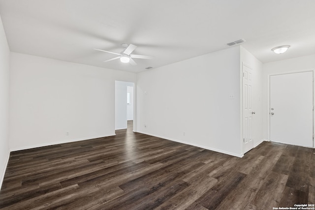 spare room with ceiling fan and dark hardwood / wood-style flooring