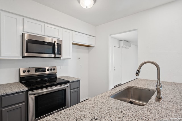 kitchen featuring white cabinetry, appliances with stainless steel finishes, and gray cabinets