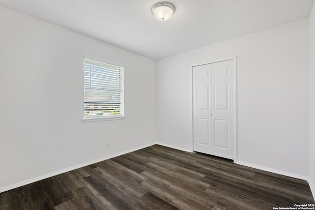 unfurnished room featuring dark hardwood / wood-style floors