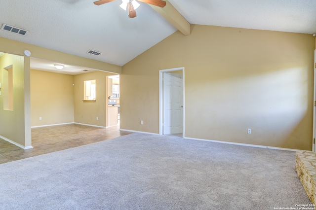 carpeted empty room featuring ceiling fan and lofted ceiling with beams