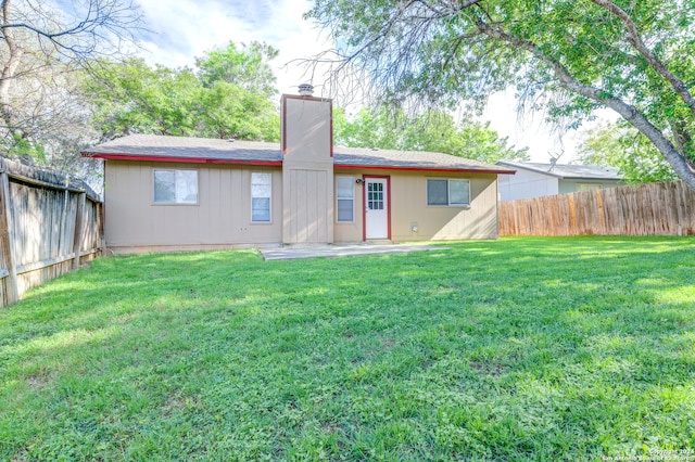 rear view of house with a lawn