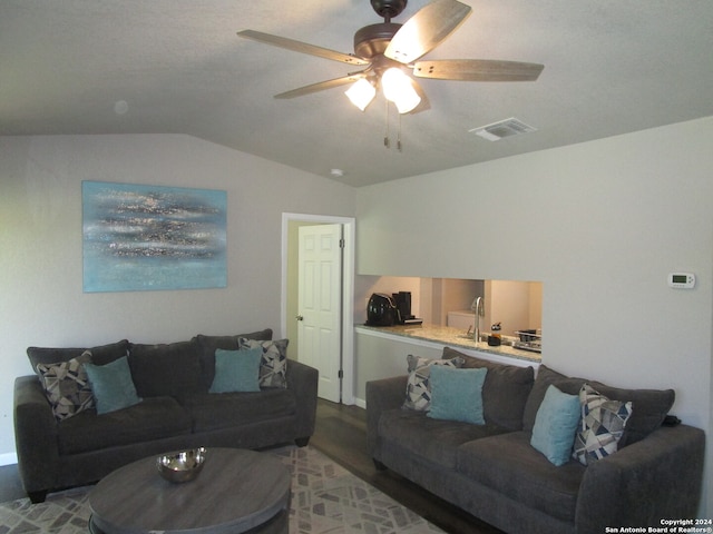 living room featuring ceiling fan, lofted ceiling, and light hardwood / wood-style flooring