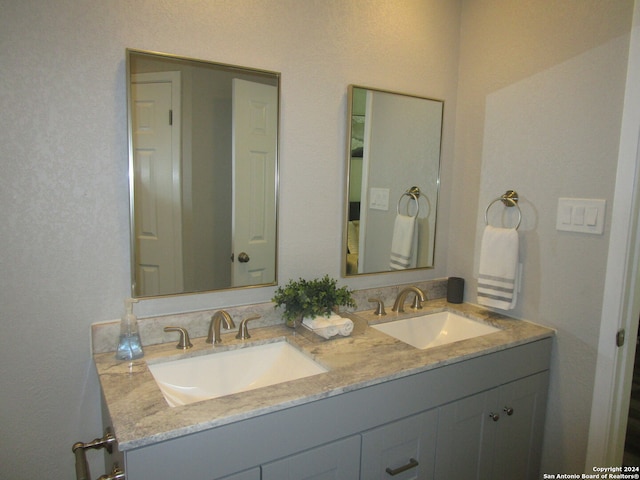 bathroom with oversized vanity and dual sinks