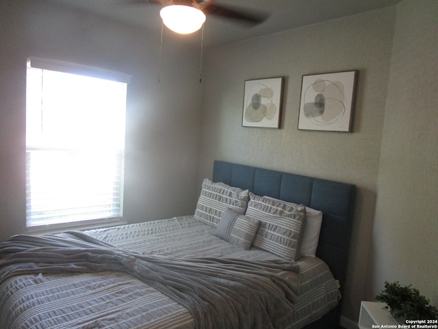 bedroom with multiple windows and ceiling fan