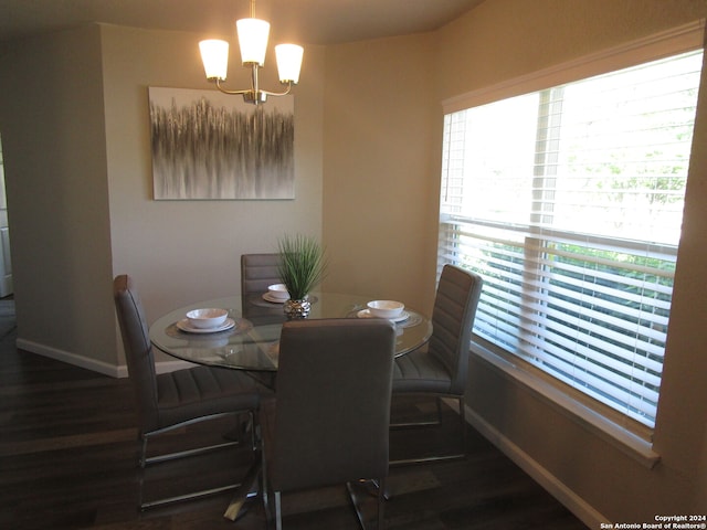 dining area featuring a chandelier and dark hardwood / wood-style floors