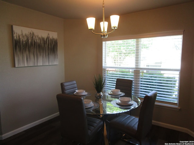 dining area featuring an inviting chandelier, dark wood-type flooring, and a wealth of natural light