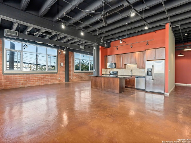 kitchen featuring appliances with stainless steel finishes, sink, concrete floors, and tasteful backsplash