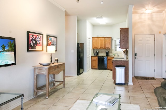 kitchen with black appliances, backsplash, light tile floors, a high ceiling, and sink