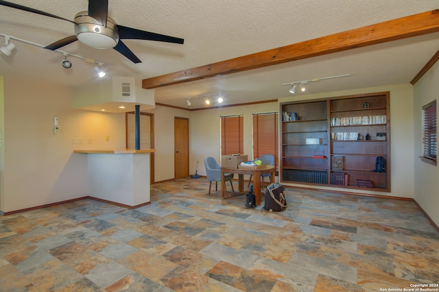 kitchen with ceiling fan, tile flooring, beam ceiling, a textured ceiling, and track lighting