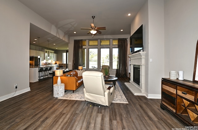 living room featuring dark hardwood / wood-style flooring and ceiling fan