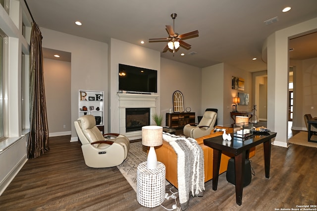 living room with dark hardwood / wood-style flooring, ceiling fan, a tile fireplace, and built in shelves