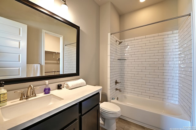 full bathroom with toilet, tiled shower / bath combo, and vanity