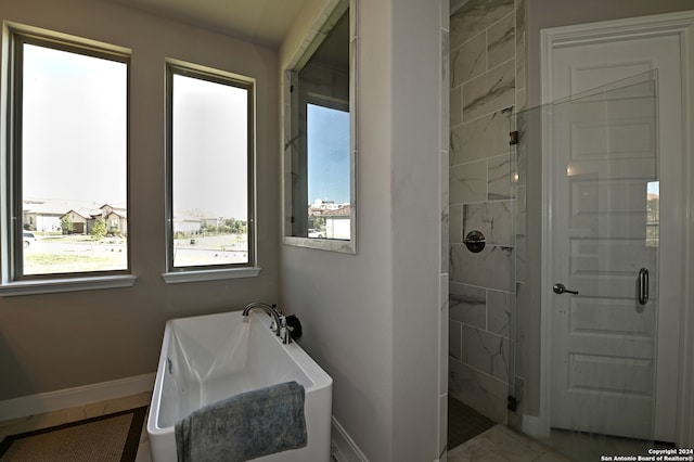 bathroom with a shower with shower door and tile flooring