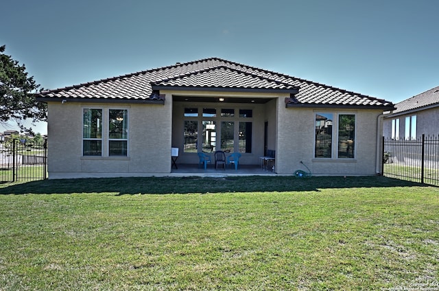 rear view of house with a yard and a patio area