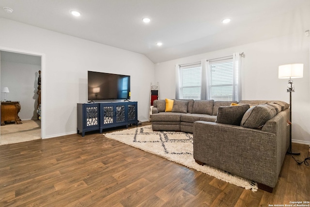 living room featuring dark hardwood / wood-style flooring and lofted ceiling